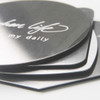 An octagonal metal coaster set featuring a shiny silver finish, stacked with a branding logo visible on top.