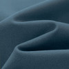 A close-up of a textured fabric in a deep blue colour, showcasing soft folds and smooth contours.