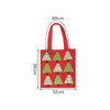 A red tote bag featuring green Christmas tree designs, with dimensions of 60cm by 36cm. It has a logo.