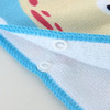 A hooded change towel featuring a colourful design with a blue border and snap buttons for secure closure.