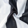 A close-up of a fabric featuring alternating black and white stripes, showcasing a smooth texture.