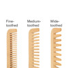 A set of three eco-friendly bamboo combs: fine-toothed, medium-toothed, and wide-toothed. Each comb displays a natural bamboo colour.