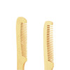 A natural small bamboo comb with handle, featuring a light golden colour and a simple design.