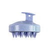 A lavender hair scalp massager with soft, pointed bristles and a sturdy handle. It has a speckled design.