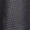 A close-up of textured black fabric with a hexagonal pattern, featuring a subtle sheen.