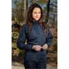 A women's thermal jacket in navy blue, featuring a front zipper and elastic cuffs, set in an outdoor environment.