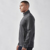 A man wearing a grey lightweight softshell jacket with a high collar and zippered pockets, featuring a logo.
