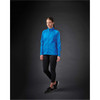 A blue women's lightweight softshell jacket is displayed on a model against a dark background, showcasing its sleek design.