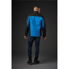 A men's softshell jacket in black and blue, featuring a logo, shown from the back on a model.