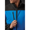 A blue and black softshell jacket with zippered pockets, featuring a person adjusting the zipper.