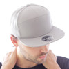 A grey cap with a flat peak, featuring a branded logo on the front.