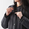 A black thermal jacket with a zip and snap buttons, featuring a fitted design and a soft lining.