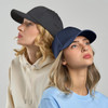A dark grey cap and a navy cap are worn by two women, set against a plain background.