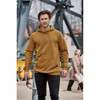 A man wearing a brown fleece pullover hoody with a front pocket, standing outdoors near industrial scenery.