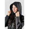 A woman wearing a black lightweight rain jacket with a hood and a logo on the sleeve.