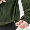 A green Women's Vertex Stormshell jacket with a person adjusting the bottom hem, featuring a logo.