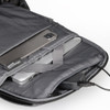 A grey backpack interior with compartments for a laptop and a smartphone, featuring a charging port.