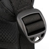 A close-up of a black backpack strap featuring a plastic buckle detail.