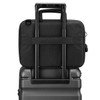 A black laptop sleeve with a handle, positioned on top of a suitcase, showcasing its sleek design.