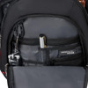 An inner pocket of a black backpack featuring compartments for a pen, keys, and a small device.