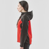 A women's softshell jacket featuring a black and red design with a hood and side zip pockets. It has a logo.
