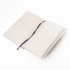 A soft smooth PU-covered notebook in light colour, featuring lined pages and a ribbon bookmark.