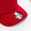 A red cap with a branding logo on the front, featuring a structured design and visible stitching.