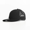 A black trucker cap with a mesh back and a round logo on the front.