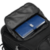 A black backpack with a partially open compartment revealing a blue notebook inside. The backpack features a logo.