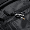 A black backpack interior with a keyring holding two silver keys. The backpack has multiple zippered compartments.