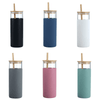 A drink bottle collection featuring six options: black, navy, white, grey, pink, and teal, with wooden lids and straws.