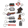 A collection of custom moulded PVC keyrings in various colours, featuring multiple designs and logos.