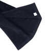 A dark navy cotton golf towel with a folded corner and a small logo.