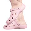 Pink clog slides with a textured surface and ventilation holes, featuring a simple logo on the side.