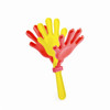 A hand clapper featuring red and yellow plastic hands on a yellow handle. It has a simple design with three clapping hands.