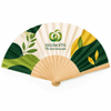 A wooden hand fan with a green and cream design, featuring leaf patterns and a logo.