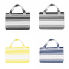 A collection of foldable beach towel bags in black, white, yellow, and navy blue, featuring striped designs and handles.