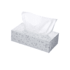 A rectangular tissue box in white with a floral design and tissues partially pulled out from the top.