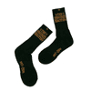 Black socks featuring a logo and text in gold, with a ribbed design and a crew length.