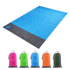 A blue polyester picnic blanket with a grey border, folded and stored in a colourful pouch with a carabiner.