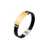 A colour engraved bracelet featuring a gold-toned rectangular plate on a black flexible band with silver accents.
