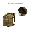 A tactical backpack in khaki with multiple compartments and a detachable velcro patch. Features straps and branding.