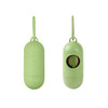 An eco-friendly green pet wastebag dispenser in a pill shape with a visible opening and a hanging loop.