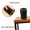 A stainless steel coffee mug in black with a leak-proof lid and non-slip bottom, featuring a logo.