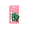 A green Christmas tree hair claw with decorations on a pink backer. Features a branding logo.