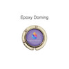 A round, foldable desk hook in gold with a purple center featuring a logo.