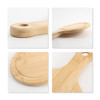 A bamboo wood pizza tray with a smooth surface and a round cutout handle, showcasing natural tones and textures.