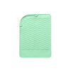 A mint green silicone pad featuring a wavy texture and a loop for hanging. It has a branding logo.