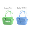 Two EVA pet bags in green and blue, featuring handles and holes for ventilation. Each bag has a logo or print design.