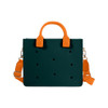 A dark green tote bag with orange handles and a detachable strap, featuring multiple hole patterns and a logo.